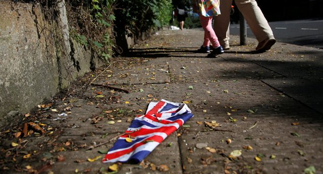 A British flag which was washed away by heavy rains the day before lies on the street in London, Britain, June 24, 2016 after Britain voted to leave the European Union in the EU BREXIT referendum.